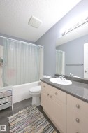 Vanity with an integrated sink, polished chrome faucet, and dark-toned countertop - 