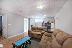 Recessed lighting, wood-finish flooring, and white trim - 
