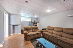 Recessed lighting, wood-finish flooring, built-in cabinetry, and a drop ceiling with square panels - 