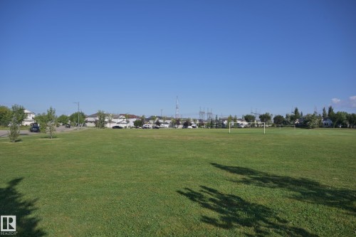 Expansive green space featuring two soccer goals and mature trees - 8127 7 Avenue Sw, Edmonton, AB 