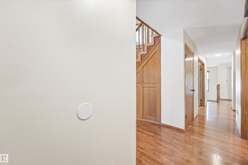 Hardwood flooring extending through the hallway - 8008 158 Avenue Nw, Edmonton, AB - Indoor Photo Showing Other Room