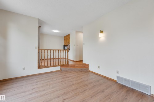 Open concept living area with wood-finish flooring - 8008 158 Avenue Nw, Edmonton, AB - Indoor Photo Showing Other Room