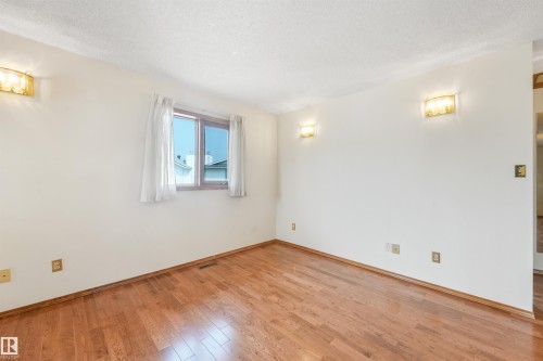 Hardwood flooring throughout - 8008 158 Avenue Nw, Edmonton, AB - Indoor Photo Showing Other Room