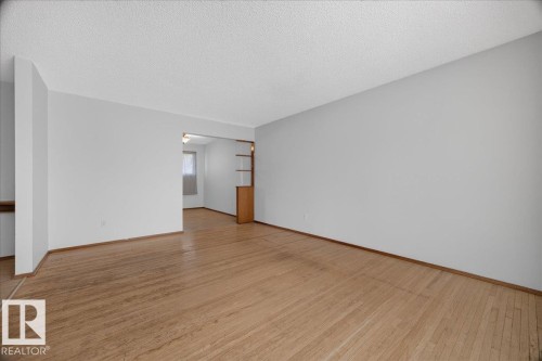 Wood-finish flooring throughout, offering a neutral color palette - 6104 92 Avenue Nw, Edmonton, AB 