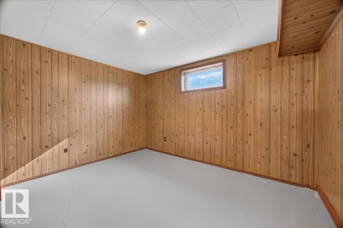 Wood-paneled walls with a dropped ceiling and recessed window - 6104 92 Avenue Nw, Edmonton, AB 