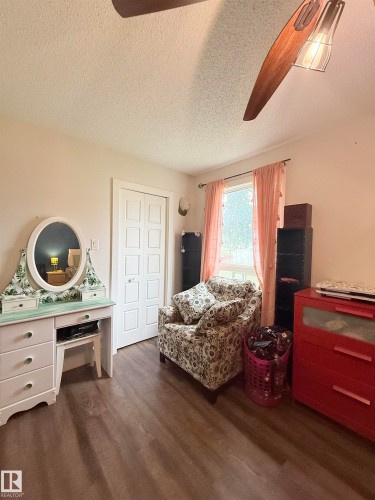 Wood-finish flooring, white bifold closet doors, and a window with natural light - #89 2703 79 St Nw, Edmonton, AB 