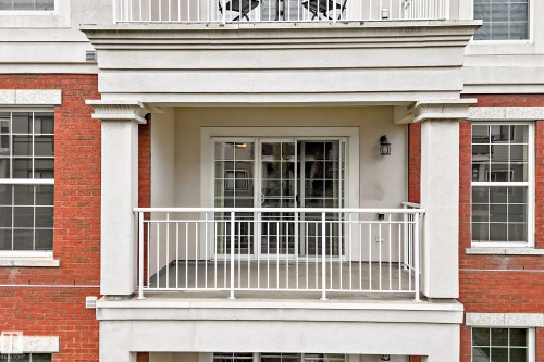 Private balcony featuring a white metal railing, concrete flooring, and sliding glass doors - #307 1003 Gault Bv Nw, Edmonton, AB - Outdoor With Balcony