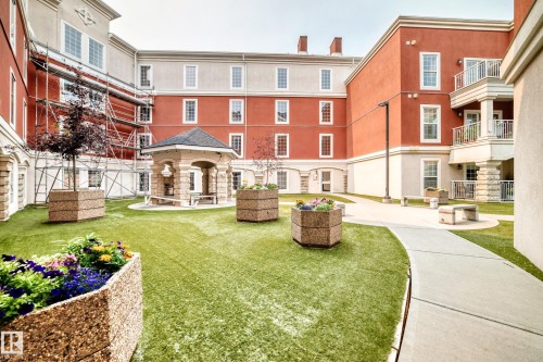 Central courtyard featuring a gazebo, stone benches, and artificial turf - #307 1003 Gault Bv Nw, Edmonton, AB - Outdoor With Balcony