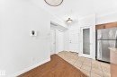 Entryway with a tiled floor and wood-finish flooring - #307 1003 Gault Bv Nw, Edmonton, AB  - Indoor 
