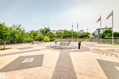 Central paved plaza featuring a circular stone fire pit - #307 1003 Gault Bv Nw, Edmonton, AB - Outdoor