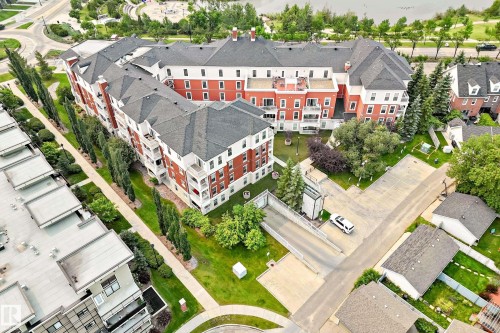 Multi-story building featuring red brick and white siding - #307 1003 Gault Bv Nw, Edmonton, AB - Outdoor With View