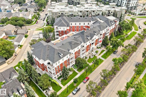 Multi-story residential building with red brick and white siding facade - #307 1003 Gault Bv Nw, Edmonton, AB - Outdoor With View