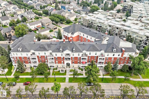 Brick and white facade building featuring multiple levels of balconies - #307 1003 Gault Bv Nw, Edmonton, AB - Outdoor With View