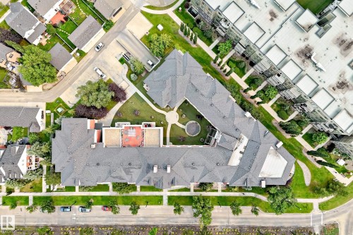 Expansive property featuring a multi-wing building with a shingled roof, surrounding a central courtyard - #307 1003 Gault Bv Nw, Edmonton, AB - Other
