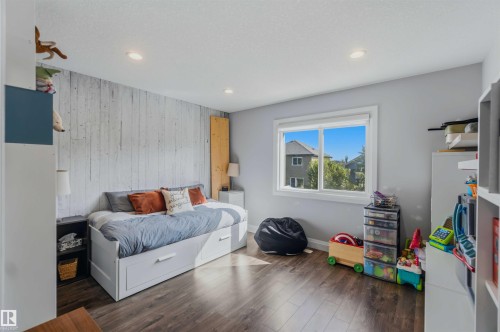 Recessed ceiling lighting, wood-finish flooring, a bright window, and an accent wall - 7 Etoile Cres, St. Albert, AB 