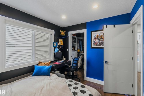 Built-in closet organization system, recessed lighting, and a modern white paneled door with contemporary hardware - 7 Etoile Cres, St. Albert, AB 
