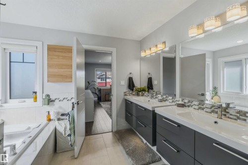 Dual vanities with white countertops, chrome faucets, and integrated sinks - 7 Etoile Cres, St. Albert, AB 