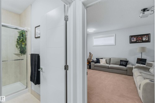 Shower enclosure with clear glass doors and a tiled interior - 7 Etoile Cres, St. Albert, AB 