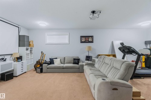 Recessed window with white trim, ceiling-mounted projector, and carpeted flooring - 7 Etoile Cres, St. Albert, AB 