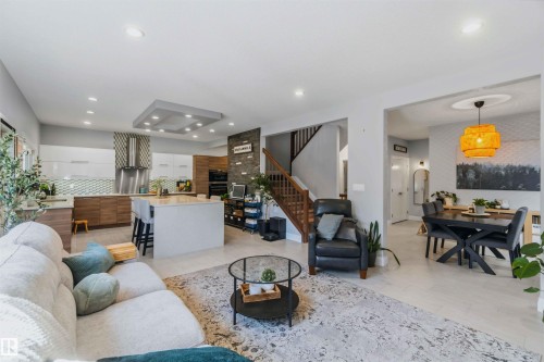 Open-concept living space with recessed lighting, a kitchen island, and stainless steel appliances - 7 Etoile Cres, St. Albert, AB 