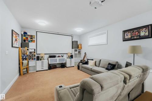 Recessed lighting, light-toned walls, and a mounted projection screen with an overhead projector - 7 Etoile Cres, St. Albert, AB 