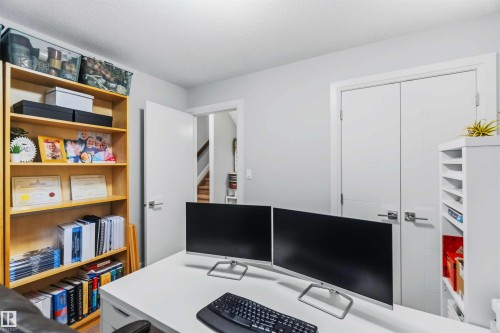 Integrated wood-finish shelving, bright white walls, and a built-in storage unit - 7 Etoile Cres, St. Albert, AB 