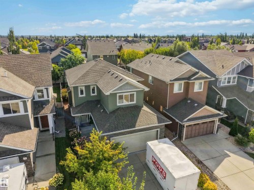 Two-story residence featuring a two-car garage, pitched roof, and a paved driveway - 7 Etoile Cres, St. Albert, AB 