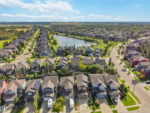 Expansive residential community featuring a central pond, established roadways, and mature trees - 7 Etoile Cres, St. Albert, AB 