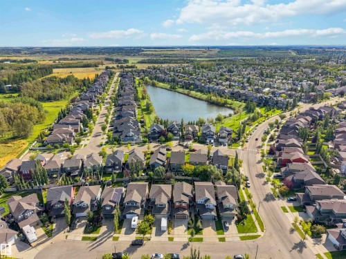 Residential community featuring a central pond, established roadways, and mature landscaping - 7 Etoile Cres, St. Albert, AB 