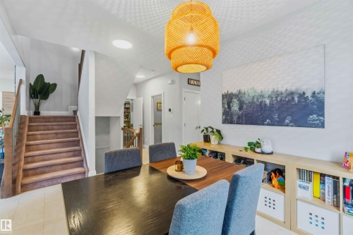 Open-concept dining area with recessed lighting and a decorative hanging light fixture - 7 Etoile Cres, St. Albert, AB 
