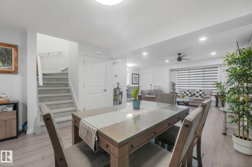 Wood-finish flooring throughout, with a carpeted staircase - 12843 67 Street Nw, Edmonton, AB 