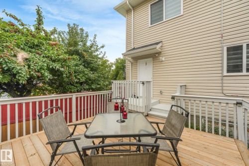 Private deck with natural wood planks and white railings - 12843 67 Street Nw, Edmonton, AB 