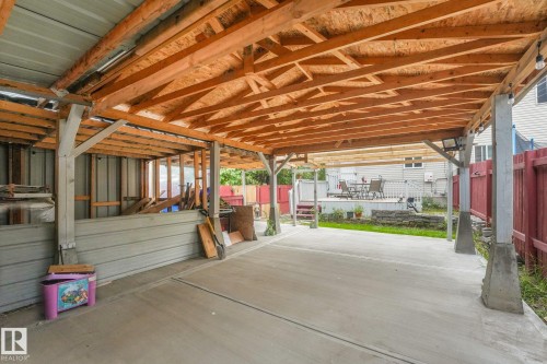 Concrete slab with a wooden beam structure, metal roofing, and concrete footings - 12843 67 Street Nw, Edmonton, AB 