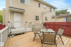Expansive wood deck with a red privacy fence and exterior siding - 