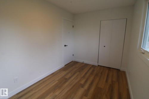 Wood-finish flooring with white walls - 4224 110 Street Nw, Edmonton, AB 