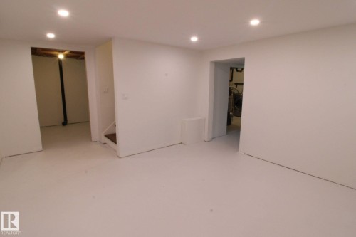 Recessed ceiling lighting, light-toned flooring, white painted walls, and open doorways - 4224 110 Street Nw, Edmonton, AB 