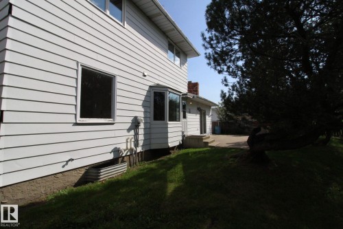 White horizontal siding exterior with a prominent bay window - 4224 110 Street Nw, Edmonton, AB 