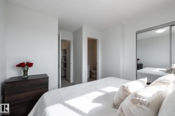 White walls with a textured ceiling, a built-in mirrored closet, and a separate room with a toilet - 