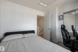 White interior paint, ceiling-mounted light fixture, sliding mirrored closet doors, paneled interior door, and light-toned carpet flooring - 