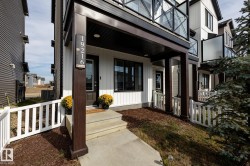 White vertical siding exterior with dark trim accents - 