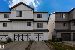 Modern multi-level exterior with crisp white vertical and horizontal siding - 