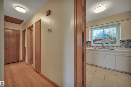 Wood-finish flooring in the hallway - 13416 102 Street Nw, Edmonton, AB 