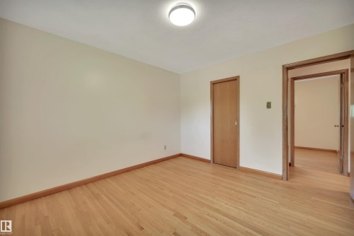 Natural wood-finish flooring with light-toned walls - 13416 102 Street Nw, Edmonton, AB 