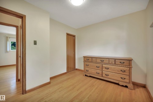 Hardwood flooring, light-toned walls, and wood-trim doorways - 13416 102 Street Nw, Edmonton, AB 
