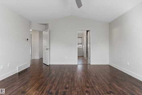 Vaulted ceiling with a ceiling fan, dark wood-finish flooring, and white trim - 17535 110 Street Nw, Edmonton, AB 