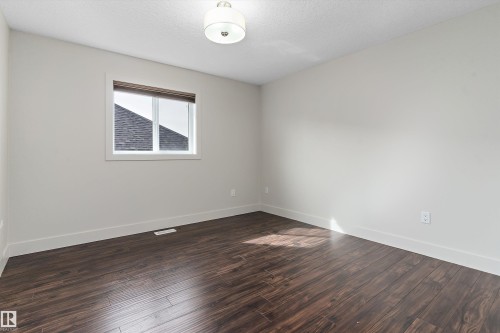 Wood-finish flooring, white trim, and a window with blinds - 17535 110 Street Nw, Edmonton, AB 