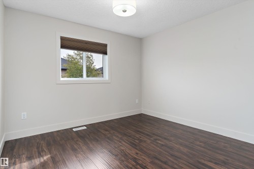 Neutral wall color, wood-finish flooring, and flush mount lighting - 17535 110 Street Nw, Edmonton, AB 