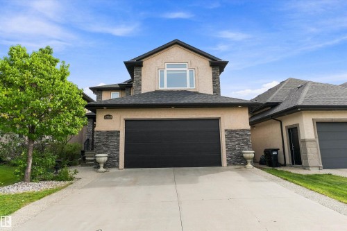 Stucco and stone exterior with a prominent two-car garage - 17535 110 Street Nw, Edmonton, AB 