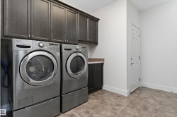 Built-in cabinetry, tile flooring, and a paneled door - 