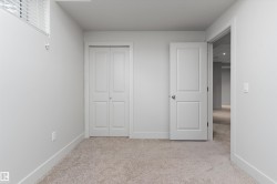Neutral tone wall finishes, carpeting, and white trim - 